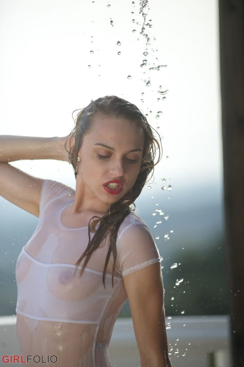 Thin teen in see thru swimsuit gets caught in a torrential downpour on balcony page 1