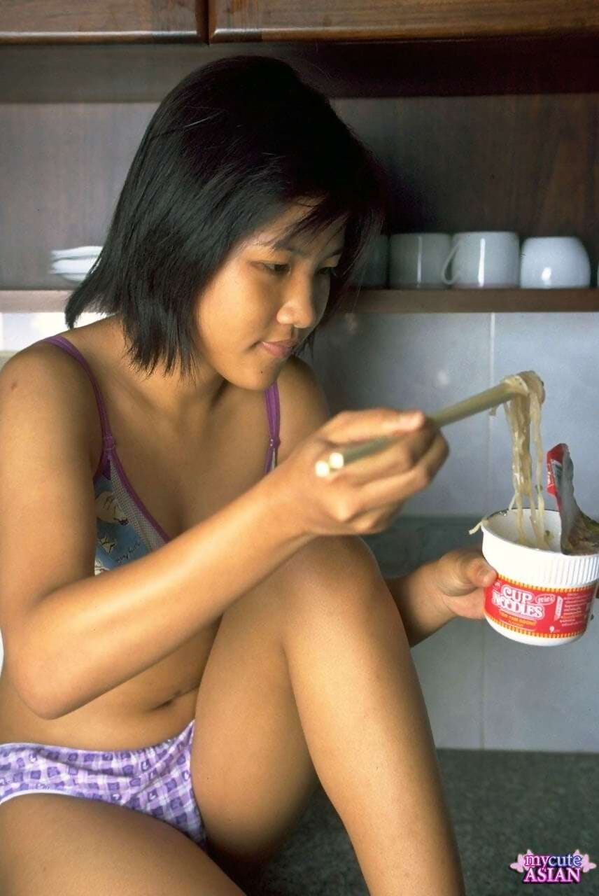 Cute Asian girl shows the pink of her pussy after eating noodles page 1