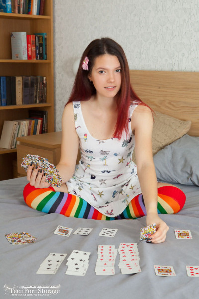 Young looking redhead Diana removes striped OTK socks to pose fully naked