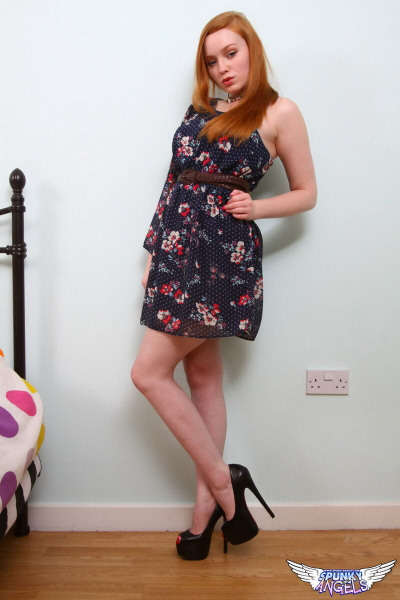 Natural redhead Kloe Kane shows some legs before getting naked on her bed