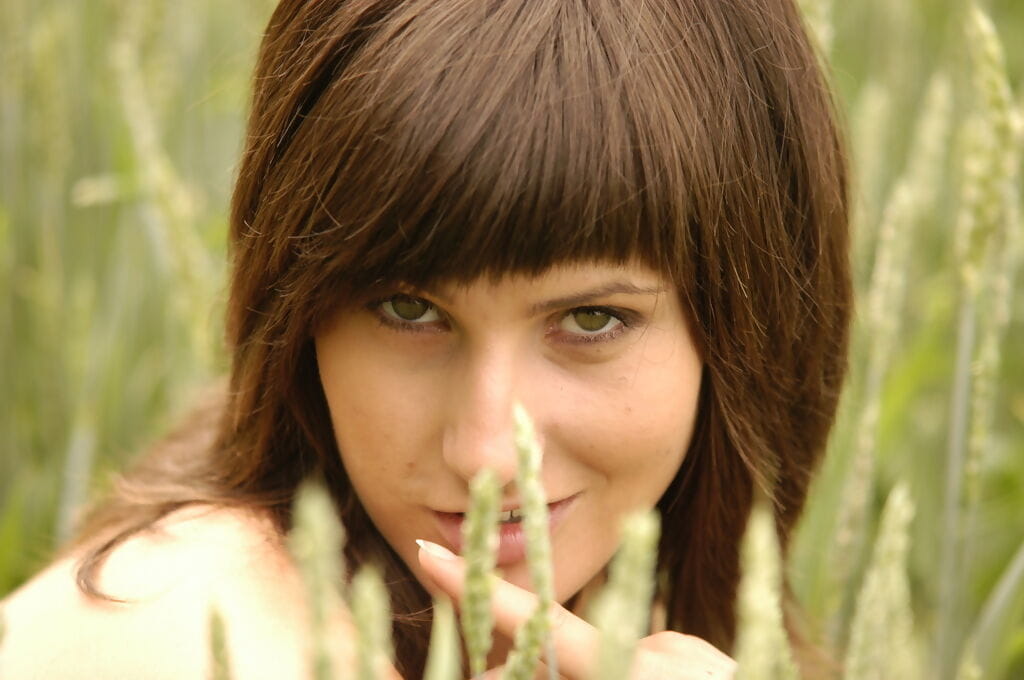 European teen Rita F uncovers her small tits while undressing in a hay field page 1