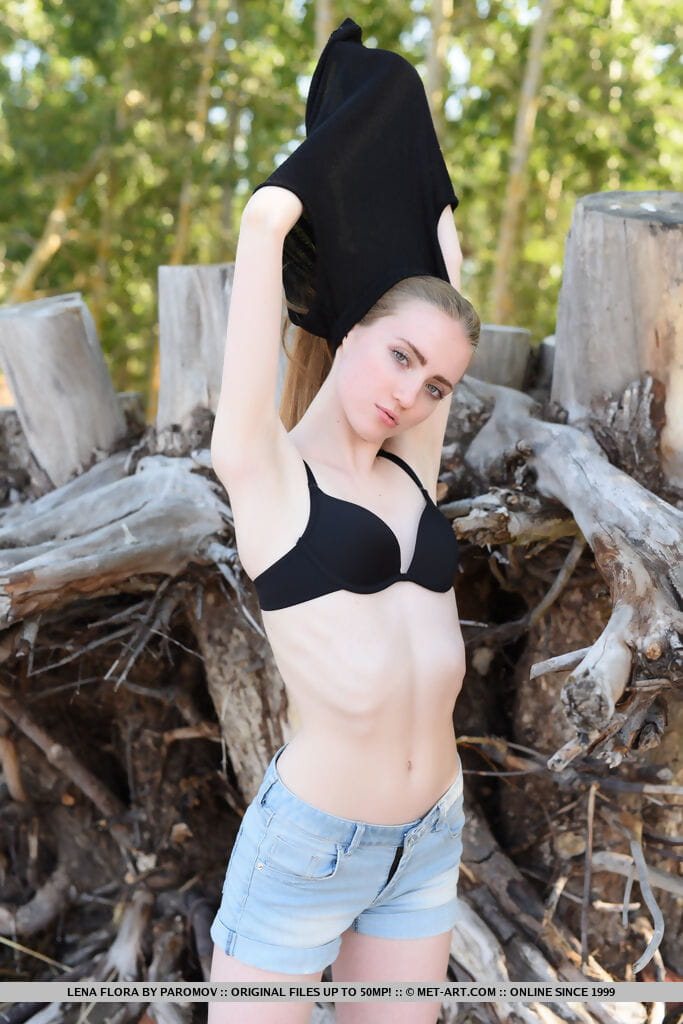 Teen solo girl with long hair Lena Flora gets naked amid driftwood on beach page 1
