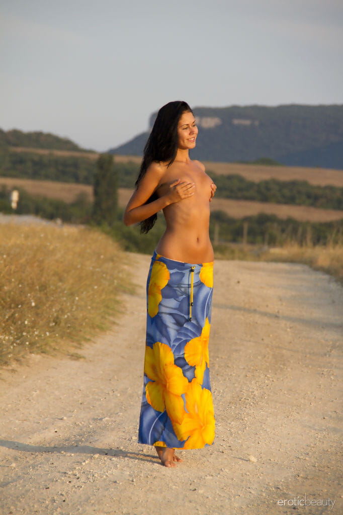 Gorgeous model Macy B drops her sarong to pose on the road with tiny tits bare page 1