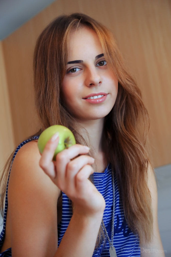 Sexy teen girl Gracie A puts down an apple before fingering her trimmed pussy page 1