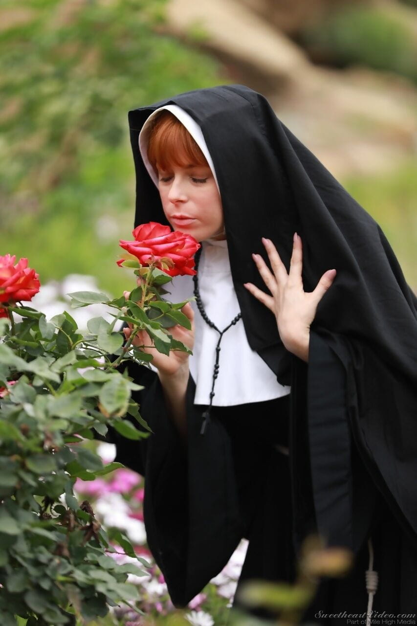 Redheaded nun Penny Pax shows off her big natural boobs and and twat page 1
