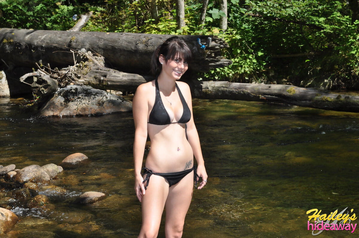 Brunette amateur Hailey removes her bikini to show wet nice tits in the river page 1