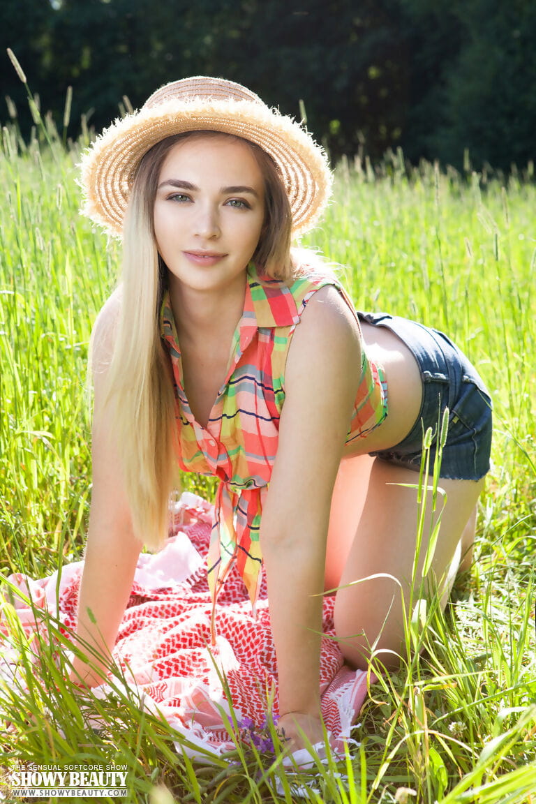 Teen first timer removes straw hat and clothes to model naked in a hay field page 1